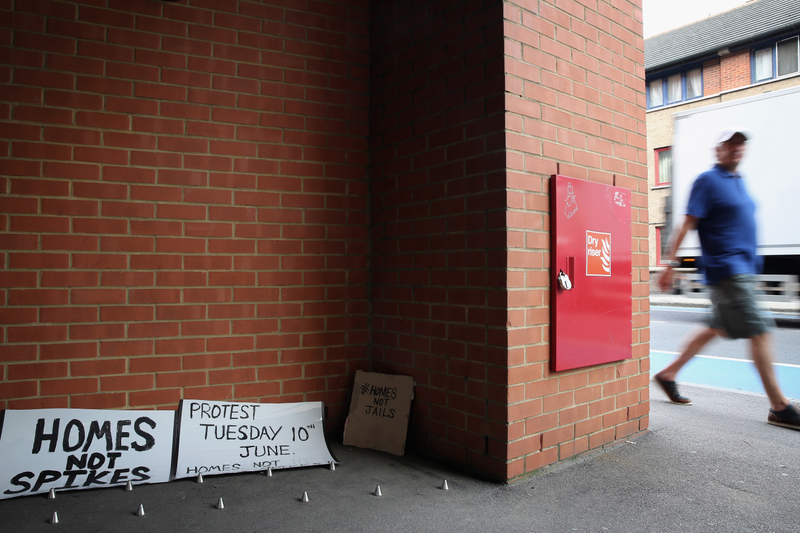 Anti-homeless spikes and protest signs around them in London, 2014 (Photo by Dan Kitwood/Getty Images)